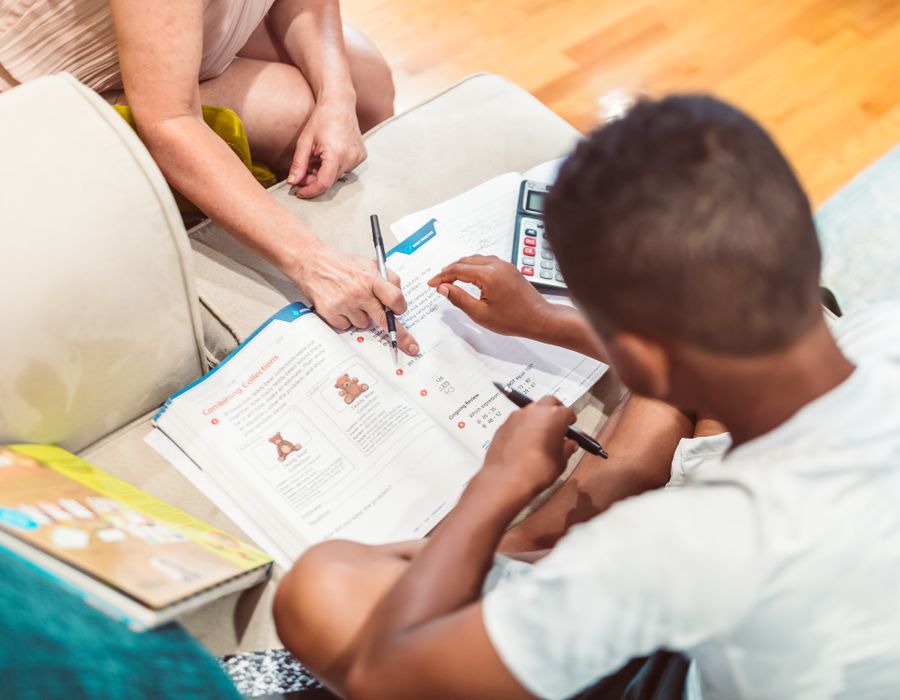 Math Notion — Home v2 1 Student working through a math workbook with a tutor