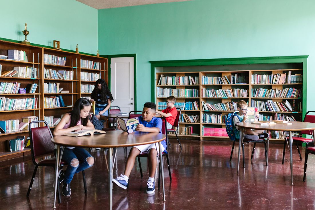 Math Notion — Home v2 12 A diverse group of students studying math books together in a library